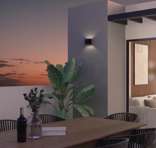 Render de terraza con comedor al atardecer